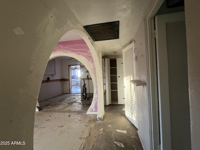 hall with a textured ceiling