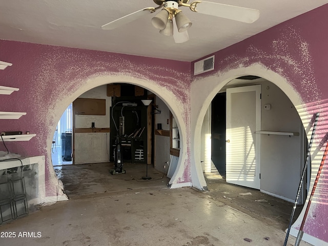 interior space featuring ceiling fan