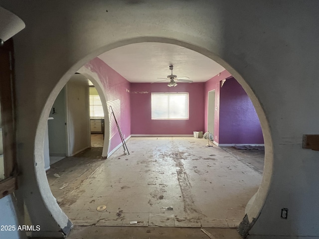 interior space with ceiling fan