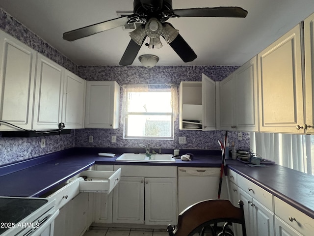 kitchen featuring light tile patterned floors, white cabinetry, ceiling fan, white appliances, and sink