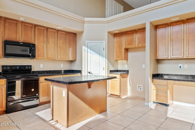 kitchen with a center island, a towering ceiling, black appliances, and light tile patterned floors