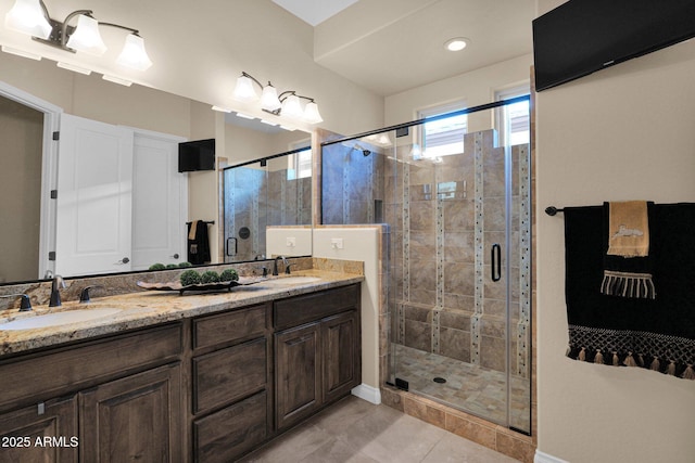 bathroom featuring tile patterned flooring, vanity, and an enclosed shower