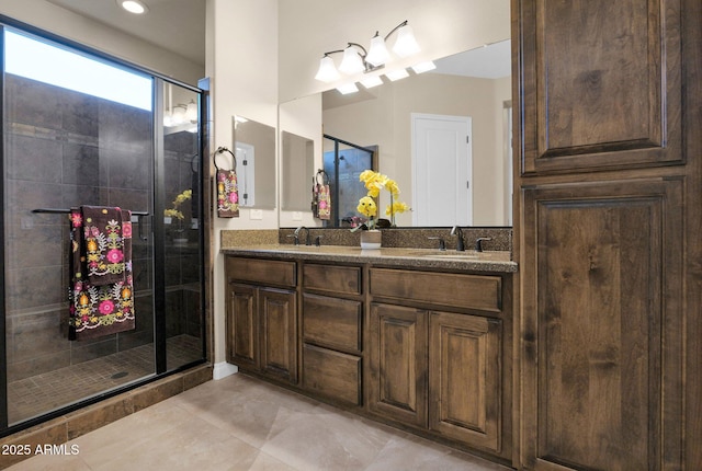 bathroom with tile patterned floors, vanity, and an enclosed shower