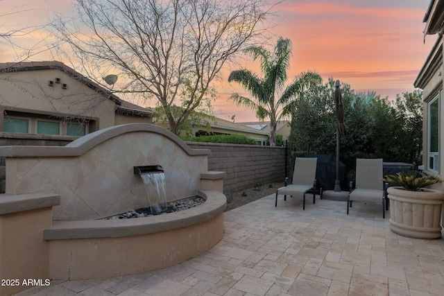 view of patio terrace at dusk