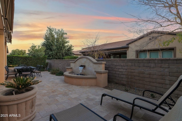 view of patio terrace at dusk