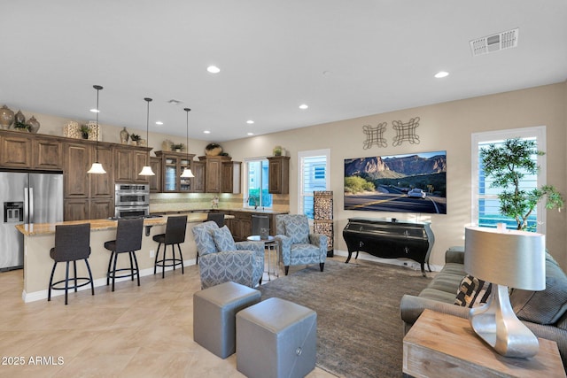 living room with plenty of natural light and light tile patterned flooring