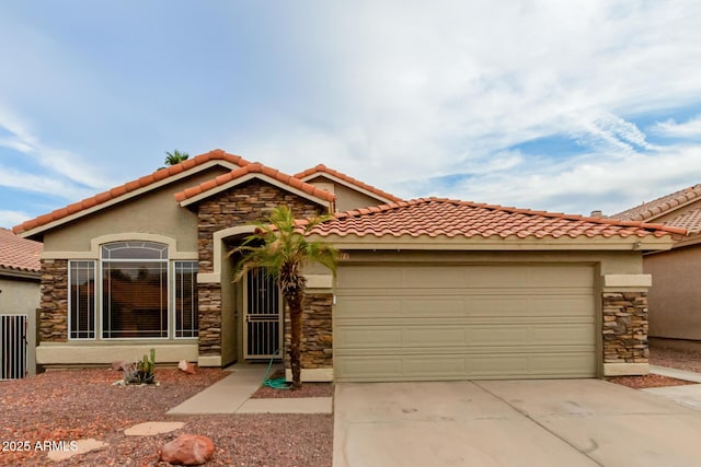 mediterranean / spanish house with driveway, an attached garage, and stone siding