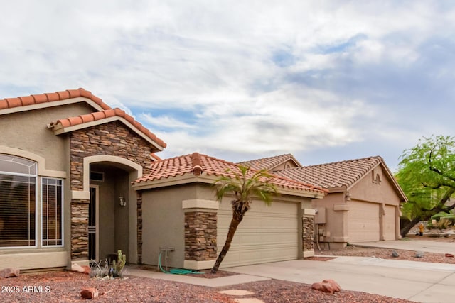 mediterranean / spanish-style house featuring a tile roof, a garage, driveway, stone siding, and stucco siding