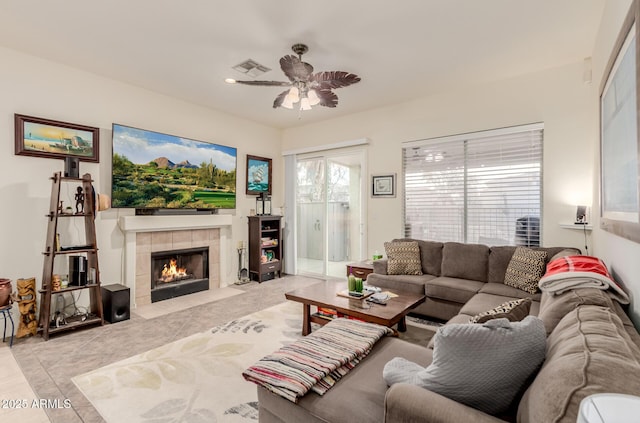 tiled living room with a tile fireplace, ceiling fan, and recessed lighting