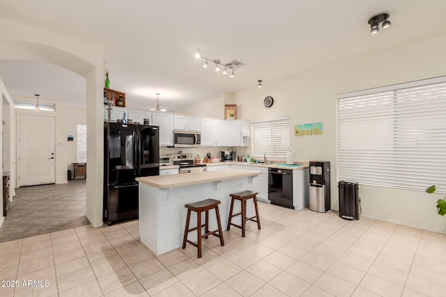 kitchen featuring a sink, light tile patterned floors, black appliances, a kitchen island, and light countertops