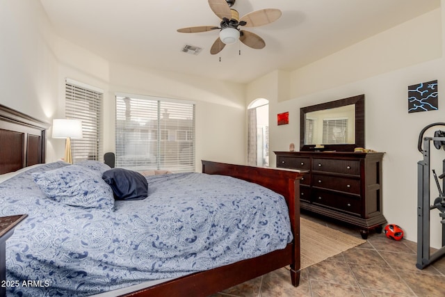 bedroom with tile patterned flooring, visible vents, and a ceiling fan