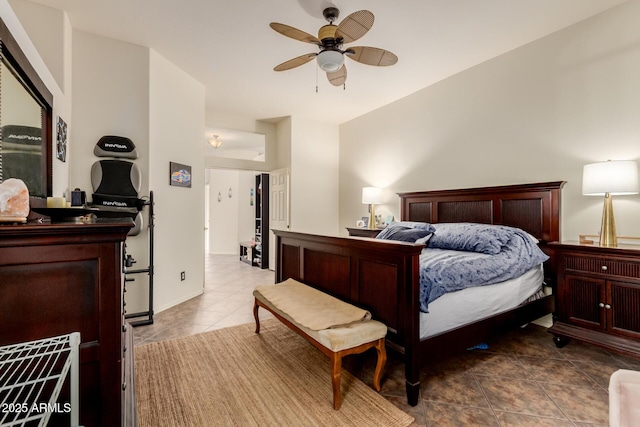 tiled bedroom featuring a ceiling fan