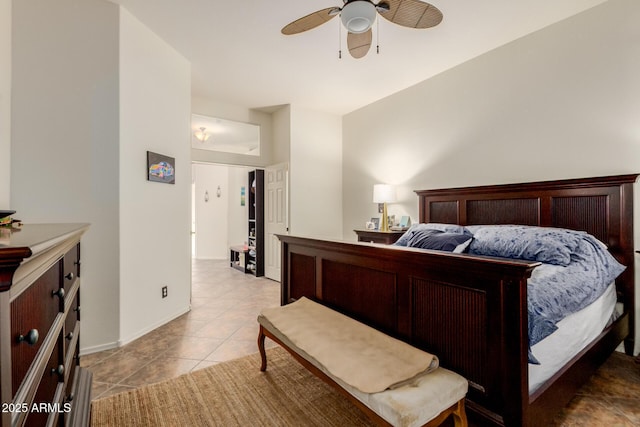 bedroom with light tile patterned floors, a ceiling fan, and baseboards