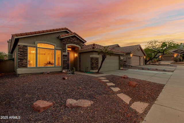 view of front of property with a garage, stucco siding, concrete driveway, and stone siding