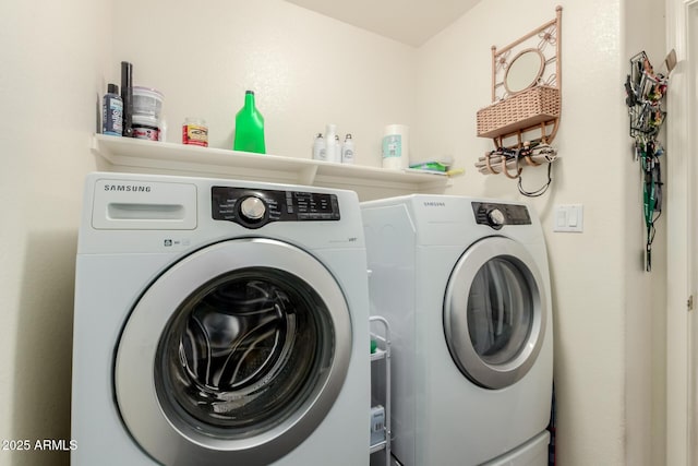 washroom with washing machine and dryer and laundry area