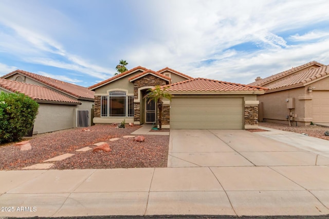 mediterranean / spanish-style house with a tile roof, a garage, driveway, stone siding, and stucco siding