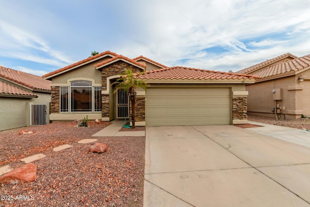 mediterranean / spanish-style home featuring a garage, stucco siding, concrete driveway, and stone siding