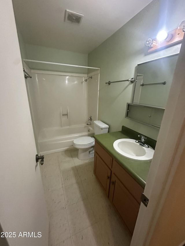 full bathroom with toilet, vanity, and shower / washtub combination