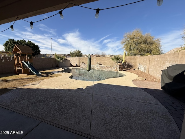 exterior space featuring a patio area, a fenced backyard, and a playground