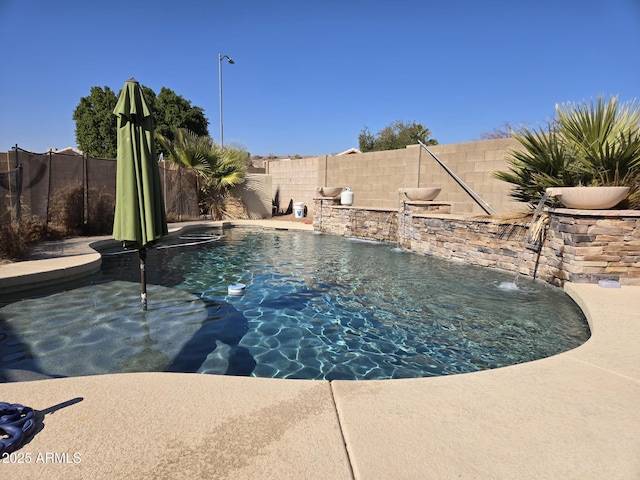 view of swimming pool featuring a fenced backyard and a fenced in pool