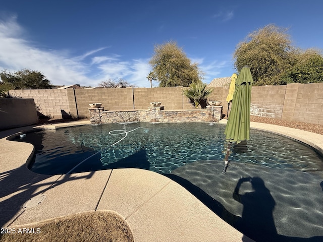 view of swimming pool featuring a fenced in pool and a fenced backyard