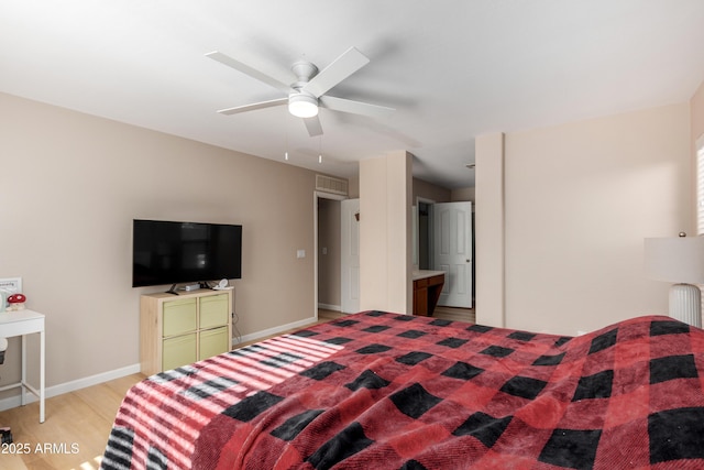 bedroom featuring ceiling fan, radiator, and light hardwood / wood-style flooring