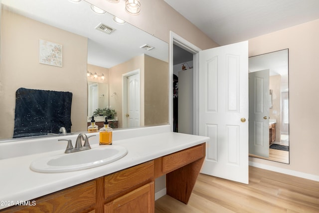 bathroom featuring hardwood / wood-style flooring and vanity