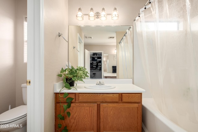 full bathroom with vanity, shower / bath combo, and toilet