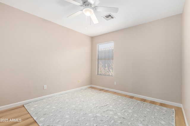 spare room with ceiling fan and hardwood / wood-style flooring