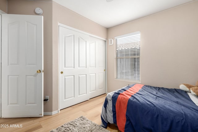 bedroom featuring hardwood / wood-style floors and a closet