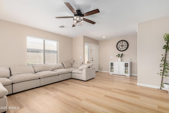 living room featuring ceiling fan and light wood-type flooring