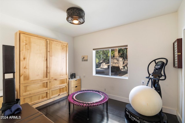 workout area featuring hardwood / wood-style floors and baseboard heating