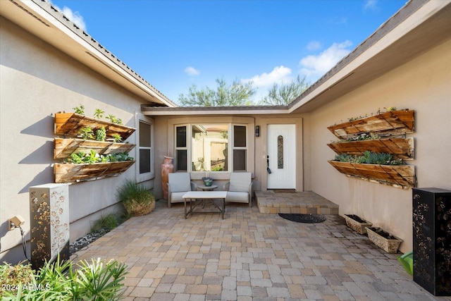 entrance to property featuring a patio