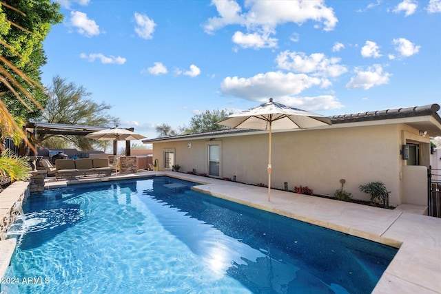 view of swimming pool featuring an outdoor hangout area, pool water feature, and a patio area