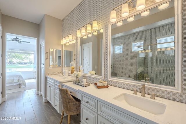 bathroom featuring vanity, ensuite bath, wood finished floors, and a stall shower