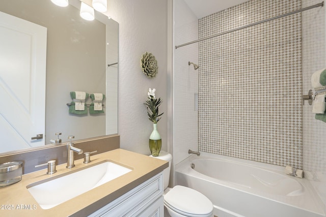 full bathroom with tub / shower combination, toilet, vanity, and a textured wall