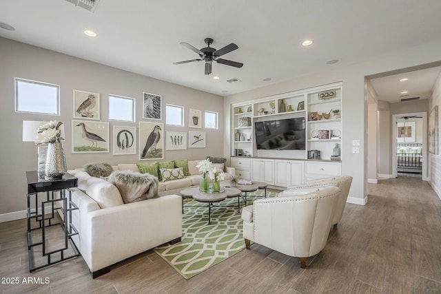 living area featuring visible vents, baseboards, recessed lighting, wood finished floors, and a ceiling fan