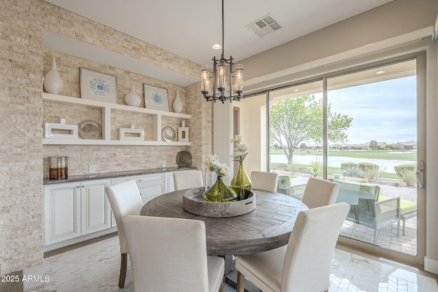 dining room with visible vents and a chandelier