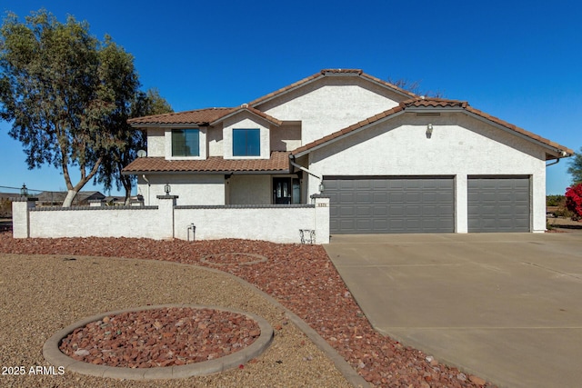 mediterranean / spanish-style house with a garage