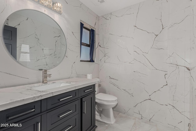 bathroom with toilet and vanity