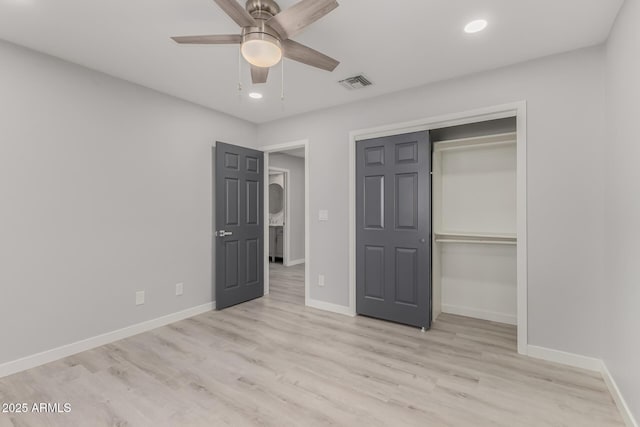 unfurnished bedroom with ceiling fan, light hardwood / wood-style flooring, and a closet