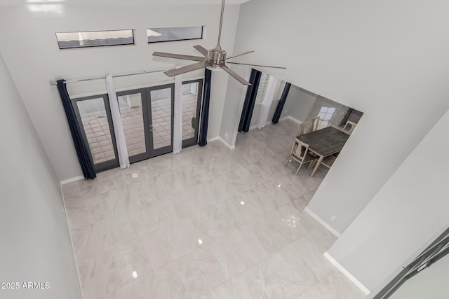 foyer entrance featuring french doors and ceiling fan