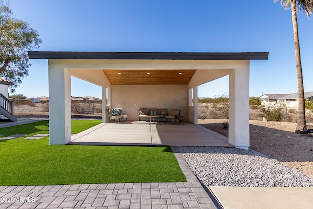 exterior space featuring a patio area, a lawn, and an outdoor living space