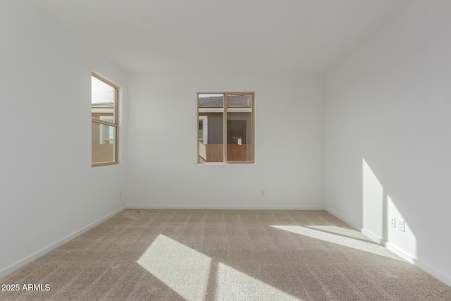 unfurnished room with light colored carpet