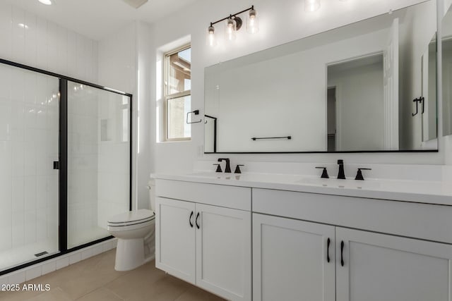 bathroom with vanity, tile patterned floors, toilet, and walk in shower