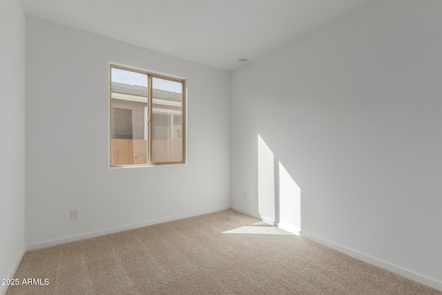 spare room featuring light colored carpet