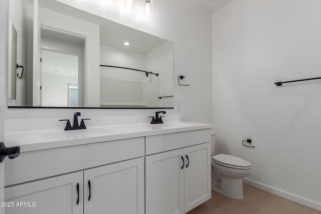 bathroom with vanity, toilet, and walk in shower