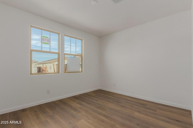 spare room featuring dark hardwood / wood-style flooring