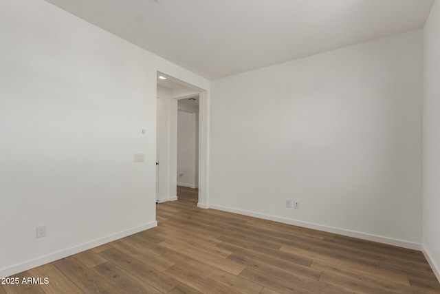 unfurnished room with hardwood / wood-style floors