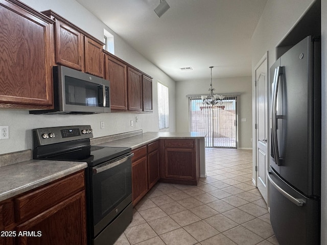 876 S Colonial Dr, Gilbert, AZ 85296 - kitchen with appliances with stainless steel finishes, a peninsula, a chandelier, light tile patterned floors, and hanging light fixtures